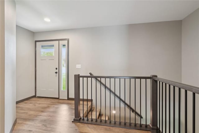 entrance foyer featuring baseboards, recessed lighting, and wood finished floors