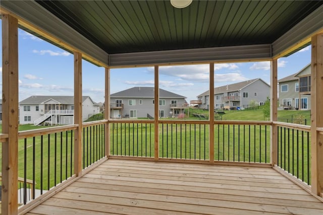 deck with a residential view and a yard