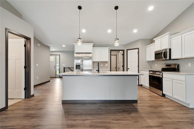kitchen featuring a sink, lofted ceiling, white cabinets, and stainless steel appliances