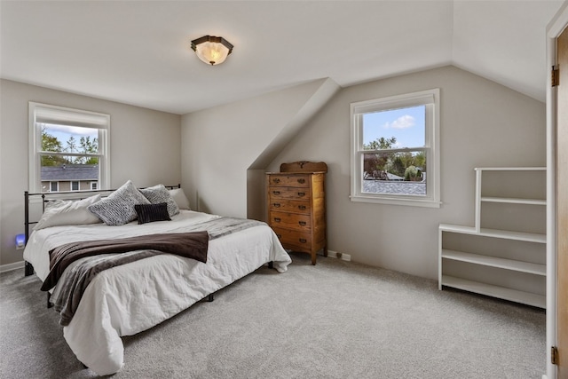 carpeted bedroom featuring lofted ceiling