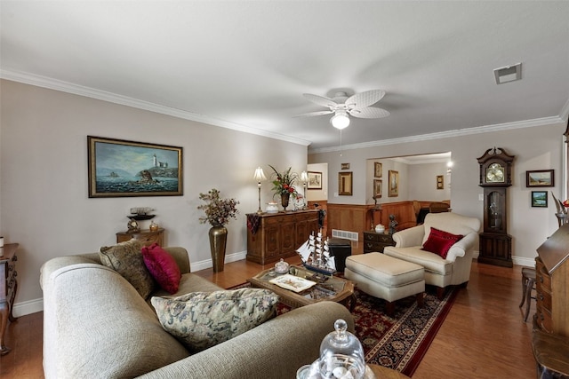 living room featuring visible vents, crown molding, ceiling fan, and wood finished floors