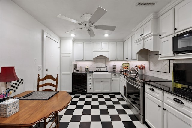 kitchen with ceiling fan, dark countertops, a sink, black appliances, and dark floors