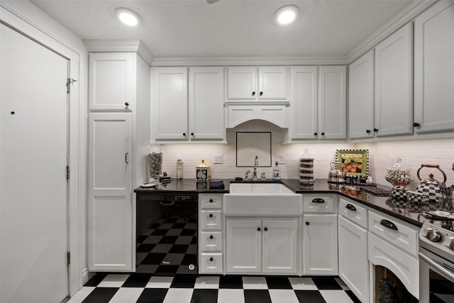 kitchen featuring dark countertops, white cabinets, dark floors, tasteful backsplash, and a sink