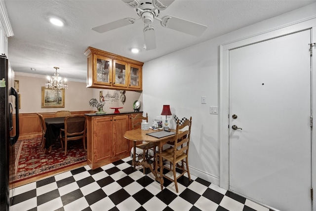 dining room with crown molding, wainscoting, ceiling fan with notable chandelier, light floors, and recessed lighting