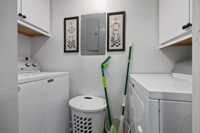 laundry room with separate washer and dryer, electric panel, and cabinet space