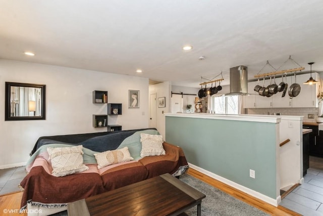 living area with recessed lighting, baseboards, and wood finished floors