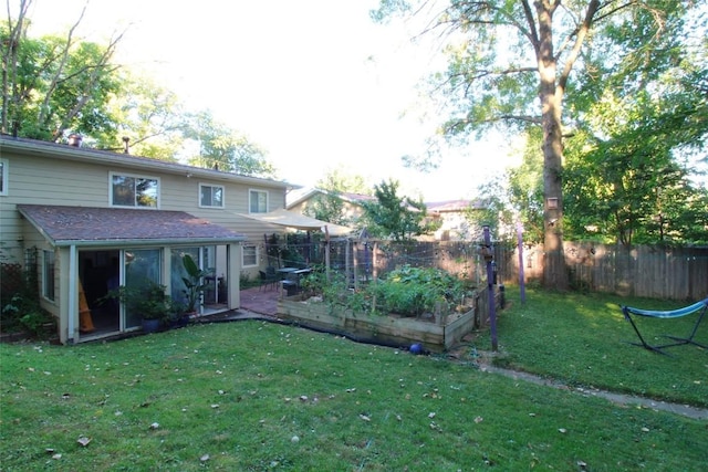 view of yard with fence and a vegetable garden