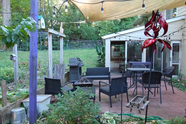 view of patio / terrace featuring an outdoor fire pit, fence, and a grill