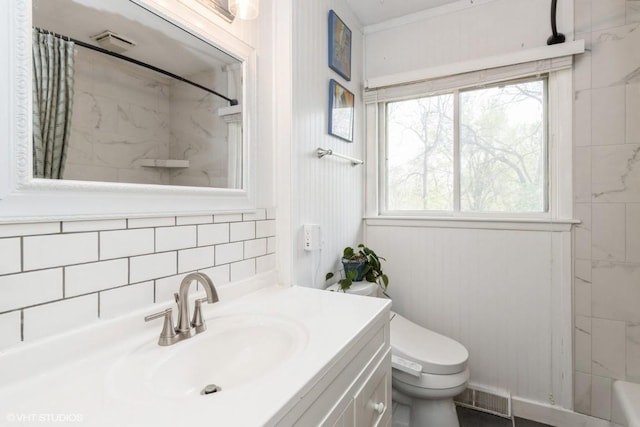 bathroom with vanity, a shower with shower curtain, visible vents, and toilet