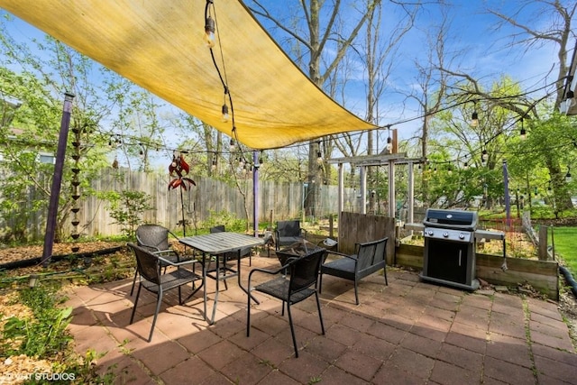 view of patio / terrace featuring fence, outdoor dining area, and area for grilling
