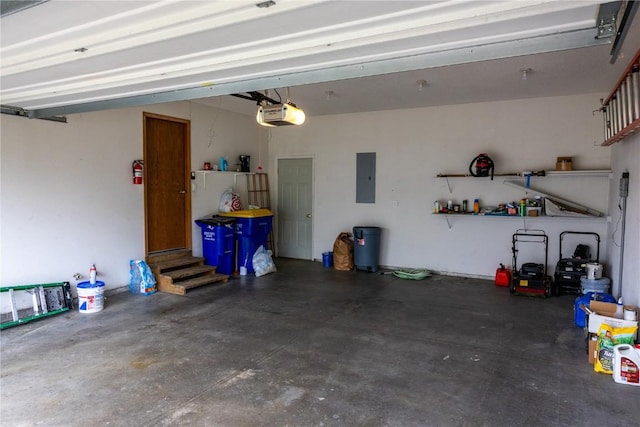 garage with a garage door opener and electric panel