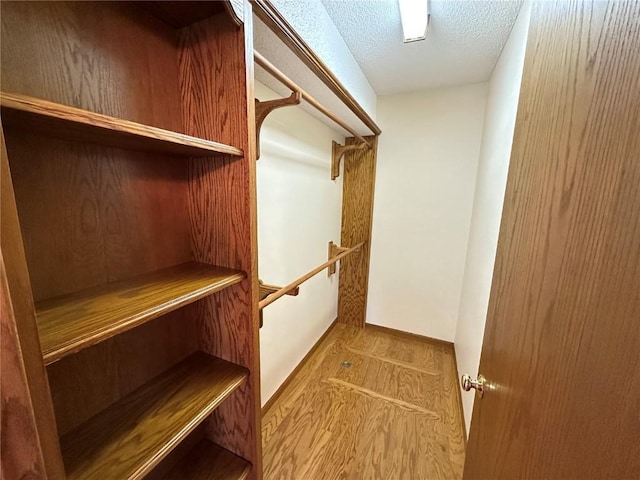 spacious closet with wood finished floors