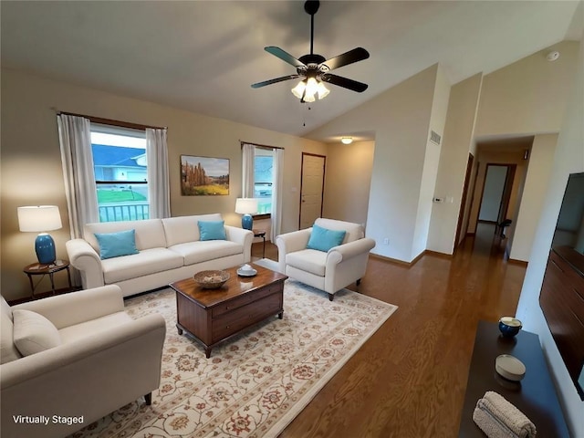 living room with baseboards, a ceiling fan, vaulted ceiling, and wood finished floors