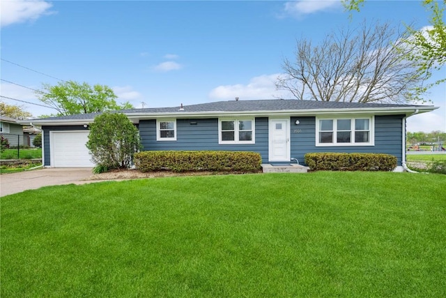 ranch-style home featuring concrete driveway, an attached garage, and a front lawn