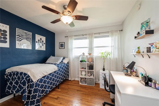 bedroom featuring a ceiling fan and wood finished floors