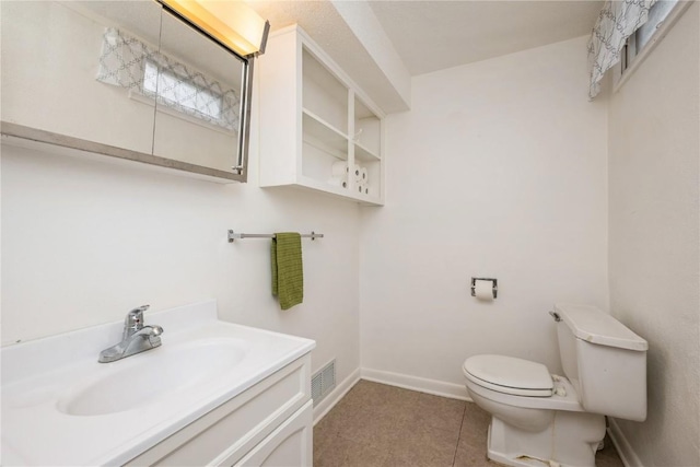 bathroom with vanity, visible vents, toilet, baseboards, and tile patterned floors