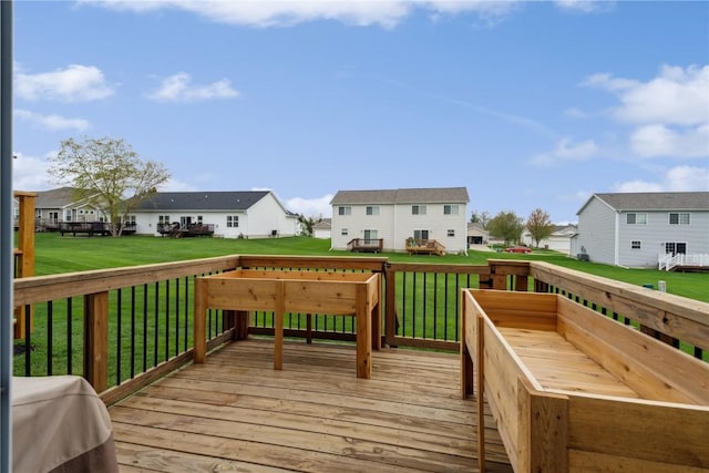 deck with a yard and a residential view