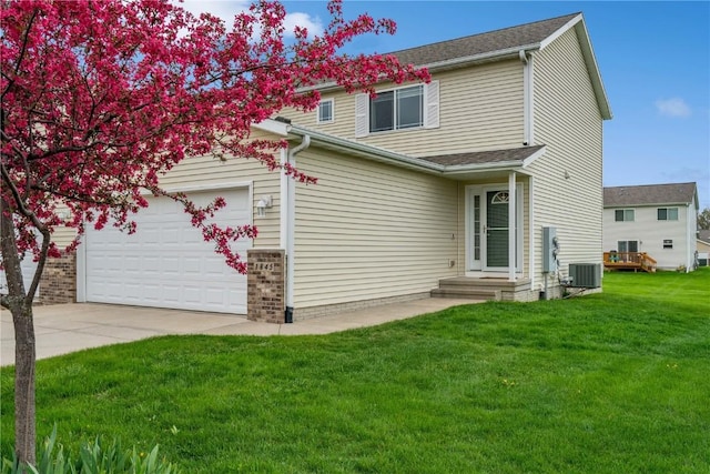 exterior space with a garage, a front lawn, central air condition unit, and driveway