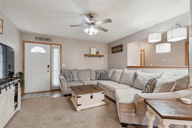 living area featuring carpet floors and ceiling fan