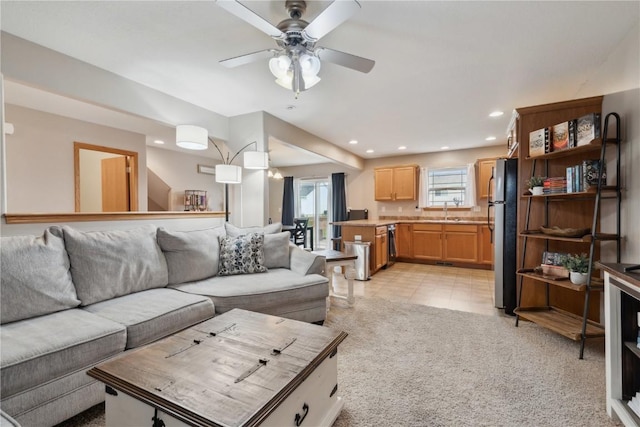 living area with recessed lighting, a ceiling fan, light tile patterned flooring, and light carpet