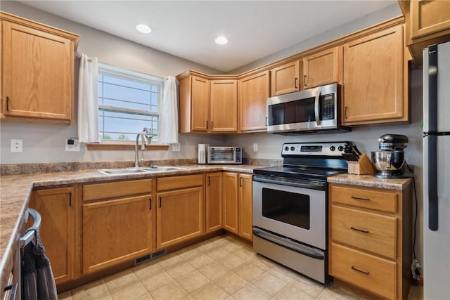 kitchen with appliances with stainless steel finishes, a sink, recessed lighting, a toaster, and visible vents