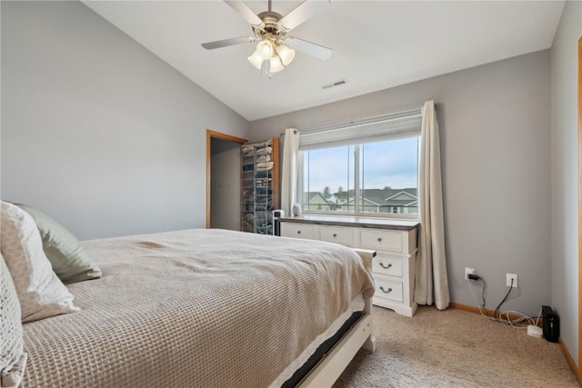 bedroom featuring ceiling fan, visible vents, vaulted ceiling, baseboards, and light carpet