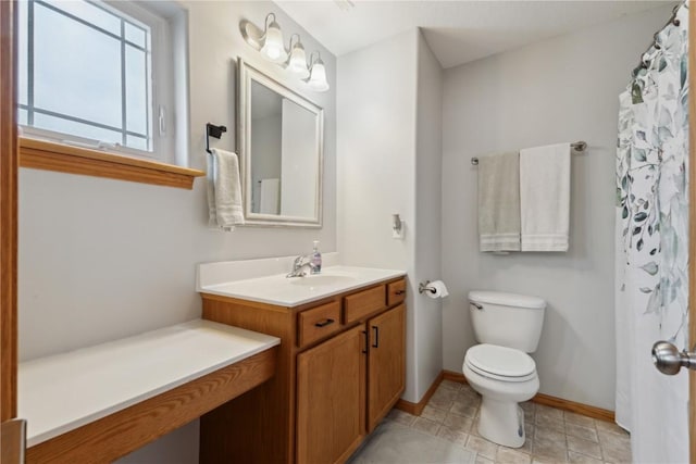 bathroom with toilet, baseboards, tile patterned flooring, and vanity