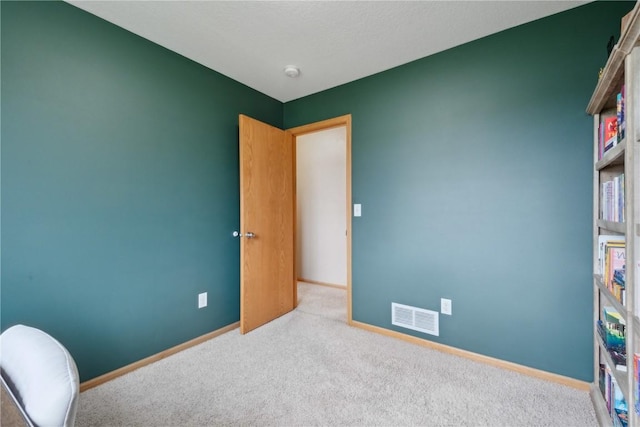 interior space with visible vents, carpet flooring, and baseboards