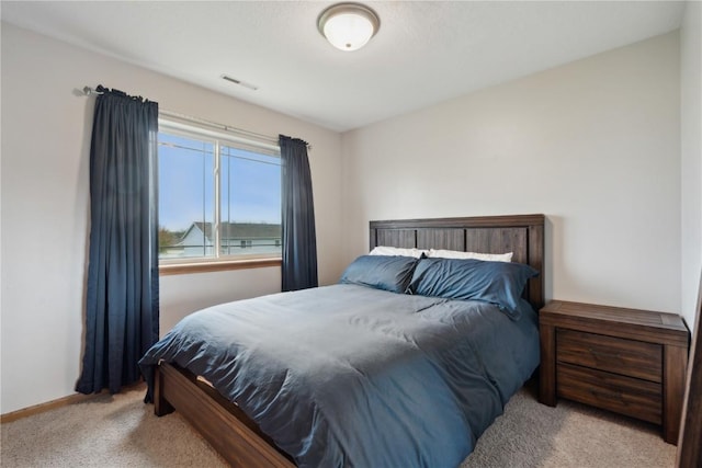 carpeted bedroom with baseboards and visible vents