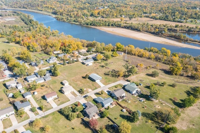 drone / aerial view featuring a water view and a view of trees