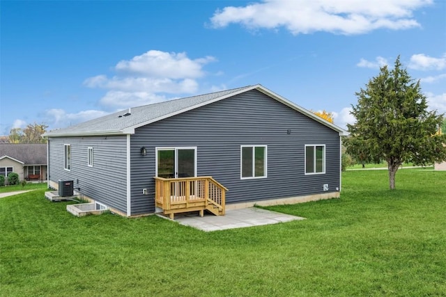 back of property with central AC unit and a yard