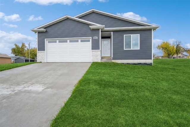 single story home featuring an attached garage, driveway, a front lawn, and stone siding