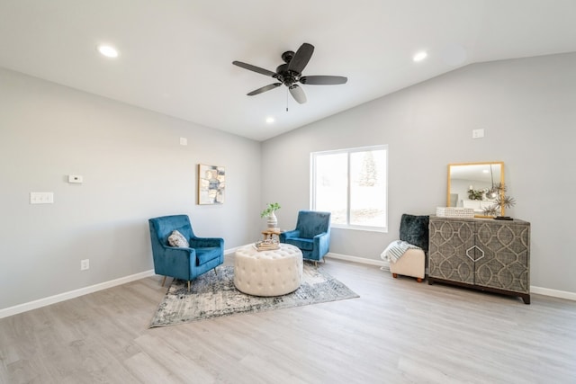 living area featuring baseboards, ceiling fan, wood finished floors, and lofted ceiling
