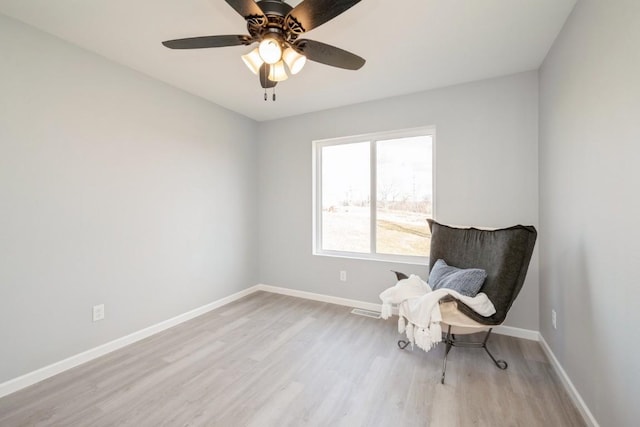 unfurnished room with baseboards, ceiling fan, wood finished floors, and visible vents