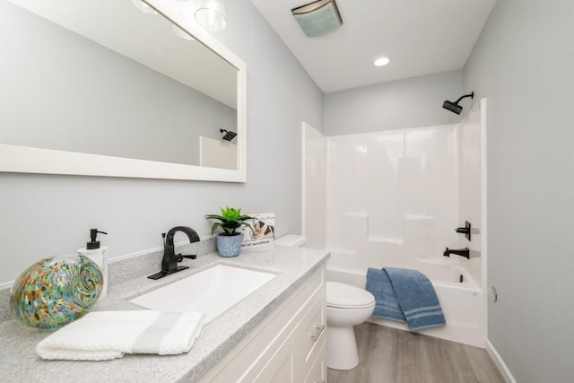 full bathroom featuring vanity, toilet, wood finished floors,  shower combination, and visible vents