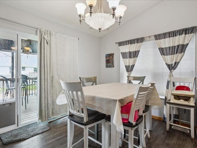 dining space featuring wood finished floors and a notable chandelier