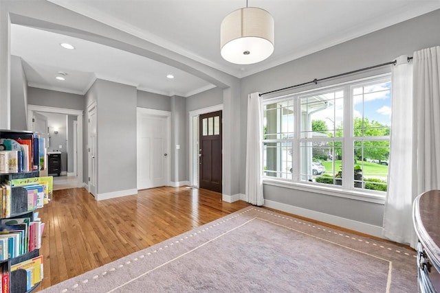 917 Robin Rd, Iowa City, IA 52246 - entryway with baseboards, a wealth of natural light, crown molding, and wood finished floors
