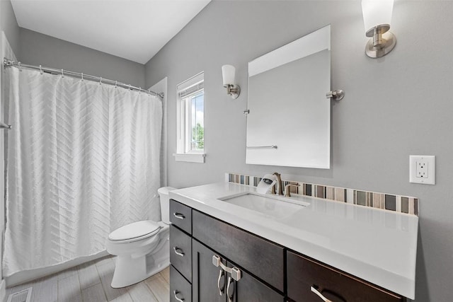 917 Robin Rd, Iowa City, IA 52246 - full bath featuring toilet, visible vents, curtained shower, vanity, and wood finished floors