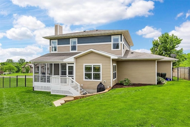 917 Robin Rd, Iowa City, IA 52246 - back of property with a sunroom, a chimney, and a lawn