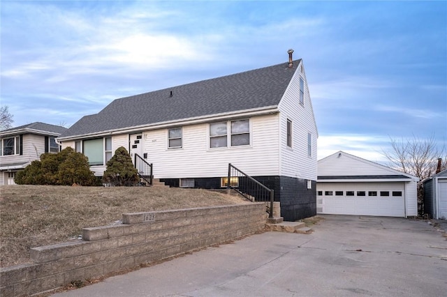 ranch-style house with an outbuilding, roof with shingles, entry steps, and a detached garage