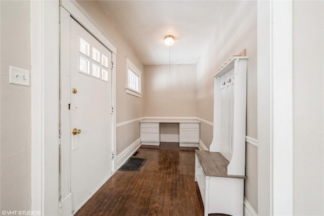 mudroom featuring dark wood-style flooring and baseboards