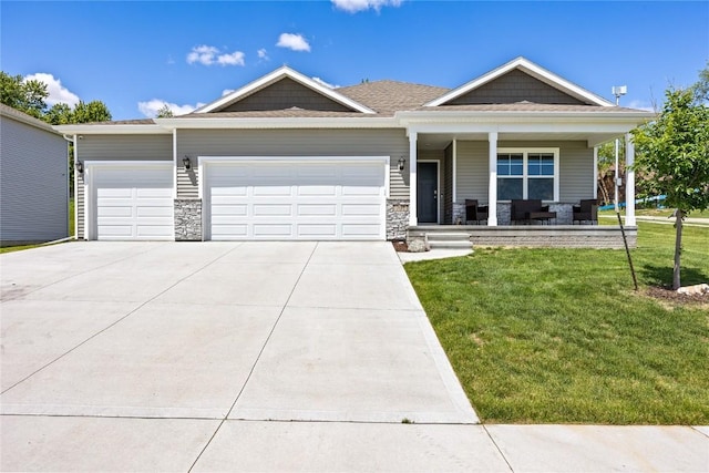 single story home with a front yard, covered porch, driveway, and a garage