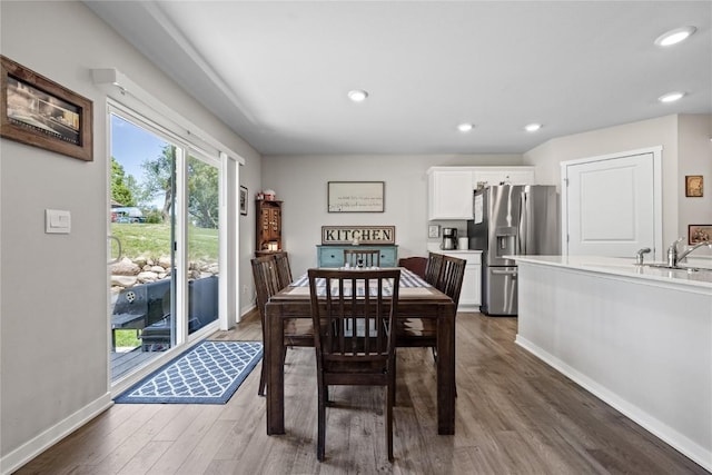 dining space featuring baseboards, recessed lighting, and wood finished floors