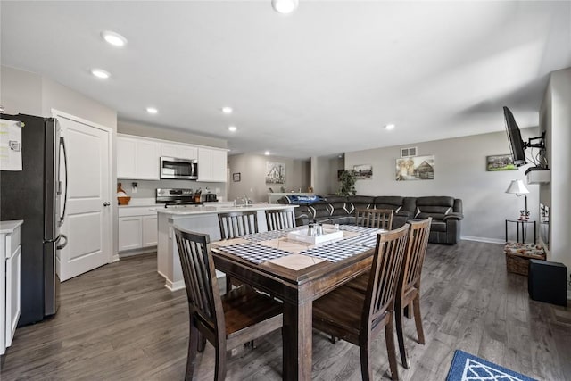 dining area featuring visible vents, wood finished floors, baseboards, and recessed lighting