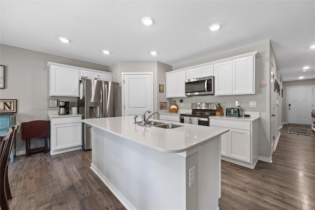 kitchen featuring a sink, light countertops, baseboards, and appliances with stainless steel finishes