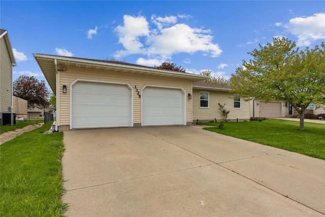 3325 29th Ave, Marion, IA 52302 - single story home with a front lawn, central AC unit, and a garage