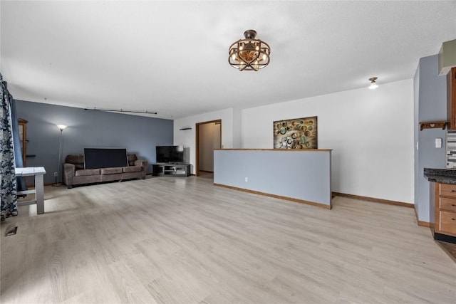 3325 29th Ave, Marion, IA 52302 - living room featuring baseboards and light wood-type flooring