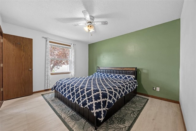 3325 29th Ave, Marion, IA 52302 - bedroom with a ceiling fan, wood finished floors, baseboards, and a textured ceiling