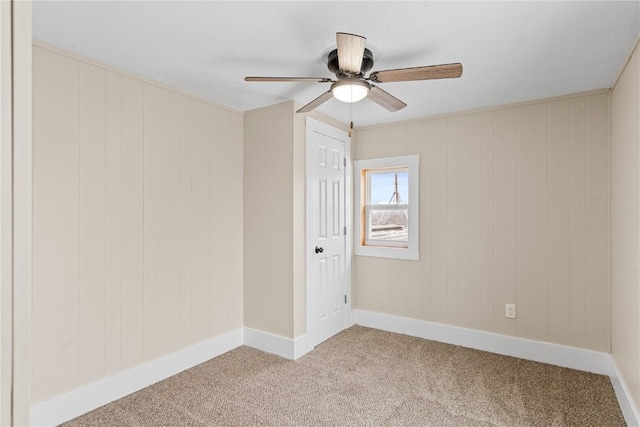 unfurnished room featuring light colored carpet, baseboards, and ceiling fan