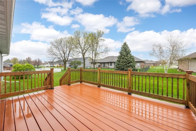 deck with a yard and a residential view